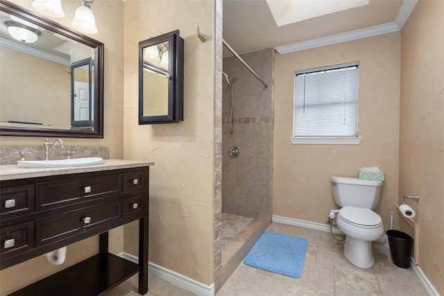 bathroom with toilet, vanity, crown molding, and tiled shower