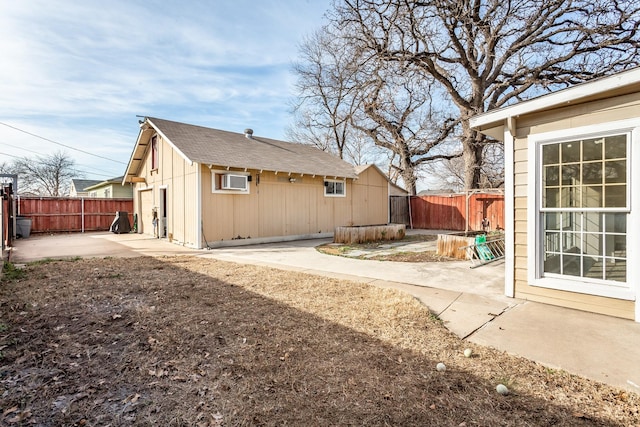 view of home's exterior with a patio and a wall unit AC