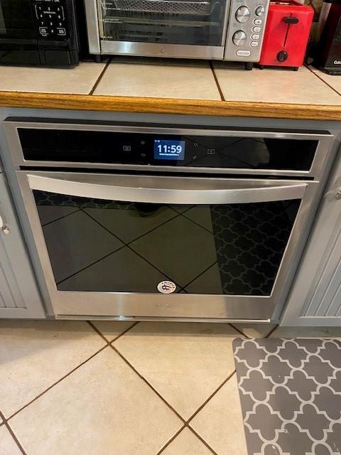 room details with stainless steel oven and gray cabinetry