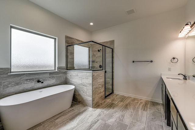 bathroom with separate shower and tub and vanity