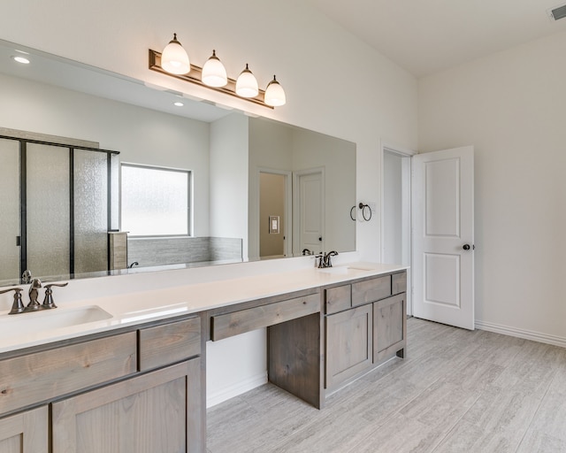 bathroom with hardwood / wood-style flooring and vanity