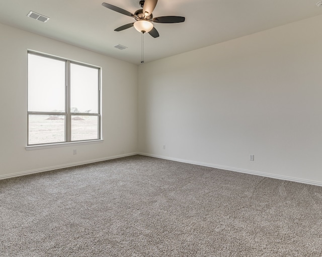 carpeted spare room with ceiling fan