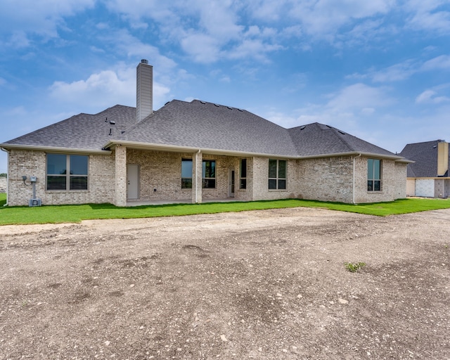 rear view of house with a lawn