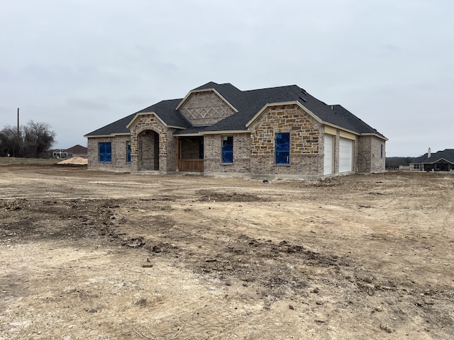 french country inspired facade featuring a garage