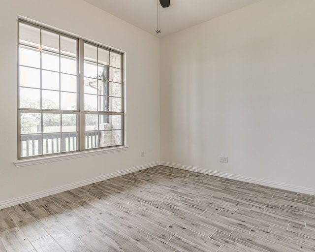 spare room with ceiling fan and light hardwood / wood-style floors