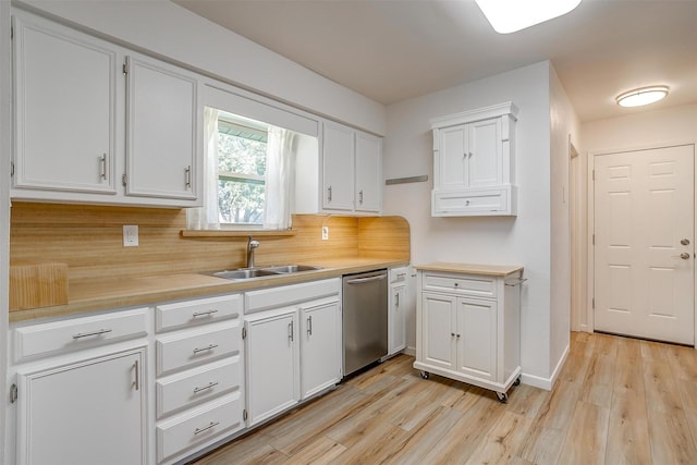 kitchen featuring light countertops, white cabinets, a sink, light wood-type flooring, and dishwasher