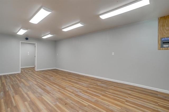 empty room featuring baseboards and light wood-style floors