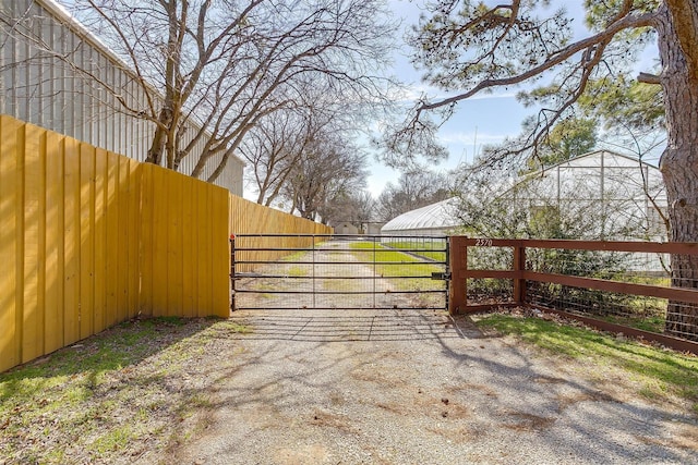 view of gate featuring fence