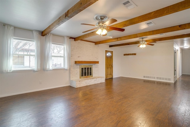 unfurnished living room with beam ceiling, dark wood finished floors, a fireplace, visible vents, and baseboards
