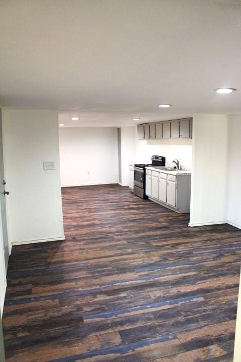 kitchen with dark hardwood / wood-style flooring, sink, electric stove, and gray cabinetry