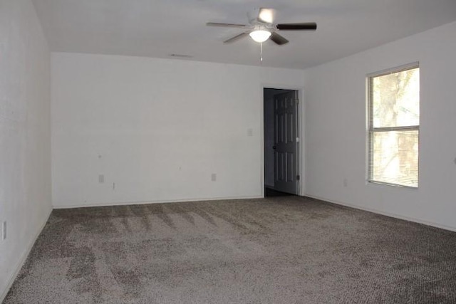 unfurnished room featuring ceiling fan and carpet floors