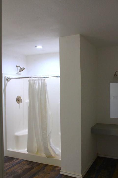 bathroom featuring hardwood / wood-style flooring and curtained shower