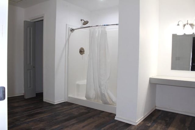 bathroom featuring hardwood / wood-style floors, curtained shower, and vanity