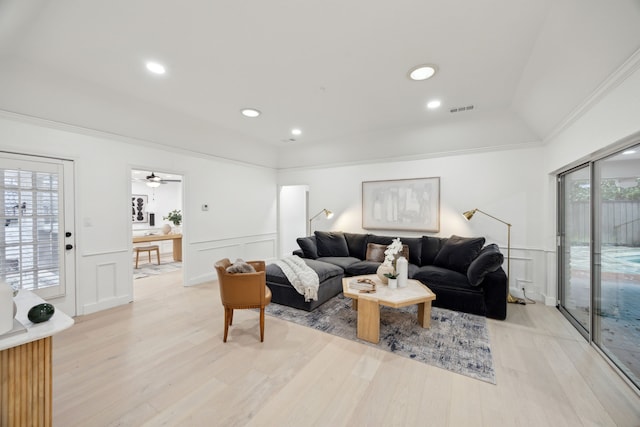 living room with light hardwood / wood-style floors and crown molding