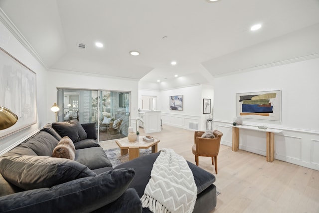 living room with light wood-type flooring and ornamental molding