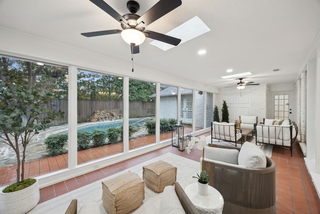 sunroom / solarium featuring a skylight and ceiling fan