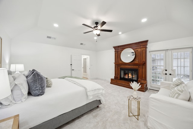 carpeted bedroom featuring a large fireplace, access to exterior, lofted ceiling, and ceiling fan