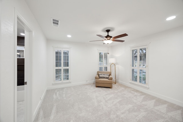 unfurnished room with ceiling fan and light carpet