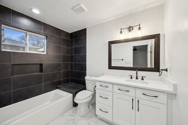 full bathroom with tiled shower / bath combo, vanity, and toilet