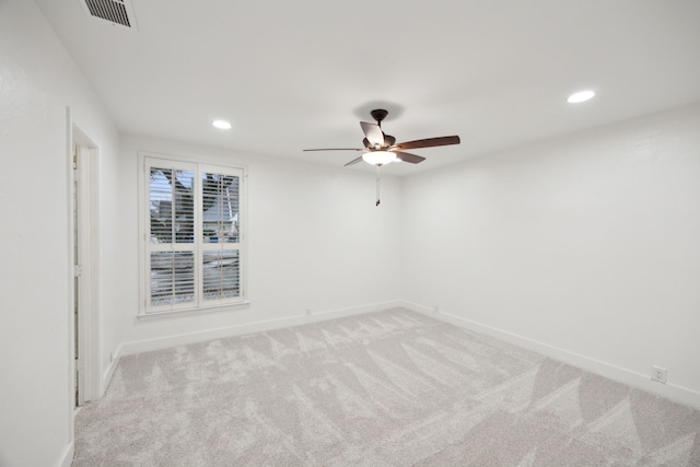 carpeted spare room featuring ceiling fan