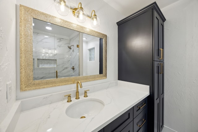 bathroom featuring vanity and tiled shower