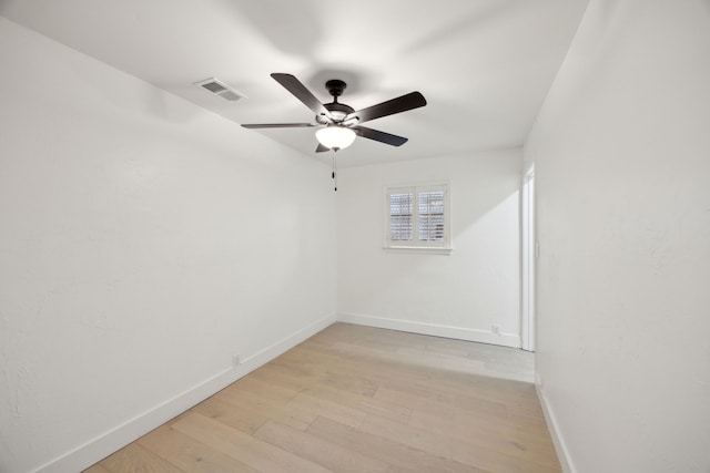 spare room with light wood-type flooring and ceiling fan