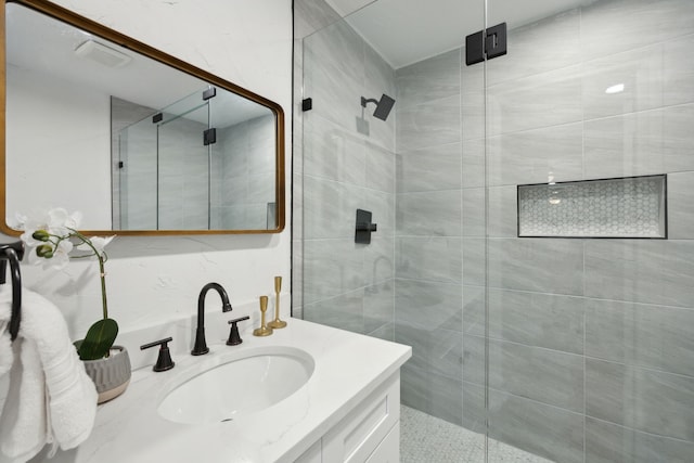 bathroom with vanity and a shower with door