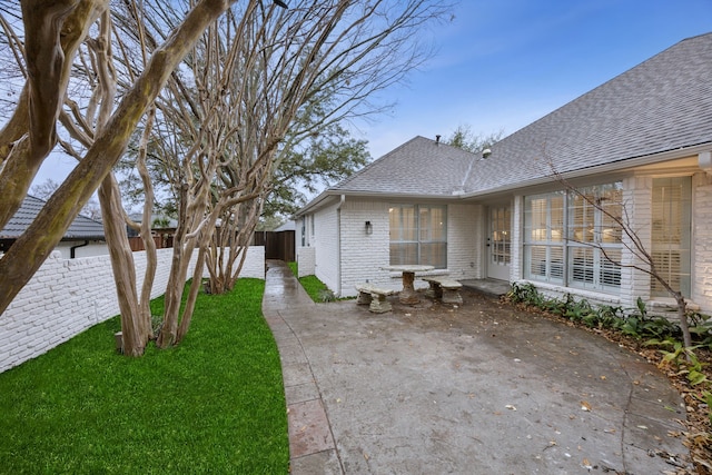 exterior space featuring a patio area and a lawn