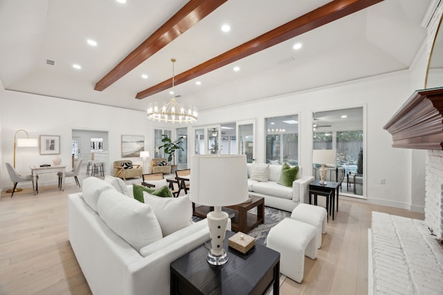 living room with beam ceiling, light wood-type flooring, a notable chandelier, and a fireplace