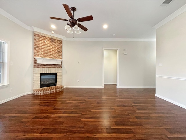 unfurnished living room featuring dark wood-type flooring, a brick fireplace, and crown molding