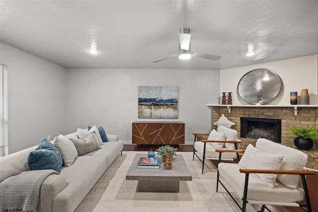 living room with ceiling fan, a fireplace, and baseboards