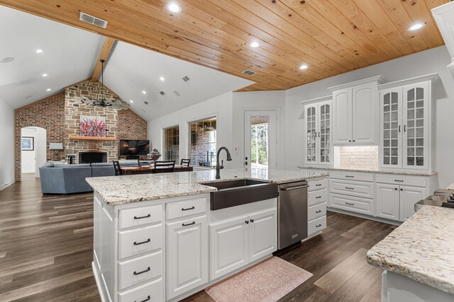kitchen featuring visible vents, a sink, glass insert cabinets, and white cabinetry