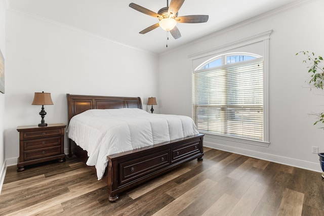 bedroom with dark wood-style floors, ceiling fan, ornamental molding, and baseboards