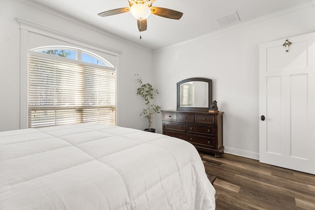 bedroom with baseboards, visible vents, a ceiling fan, ornamental molding, and dark wood-style flooring