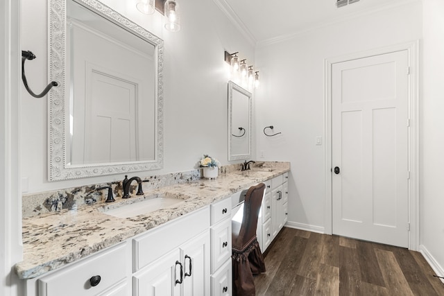 full bathroom featuring ornamental molding, double vanity, a sink, and wood finished floors