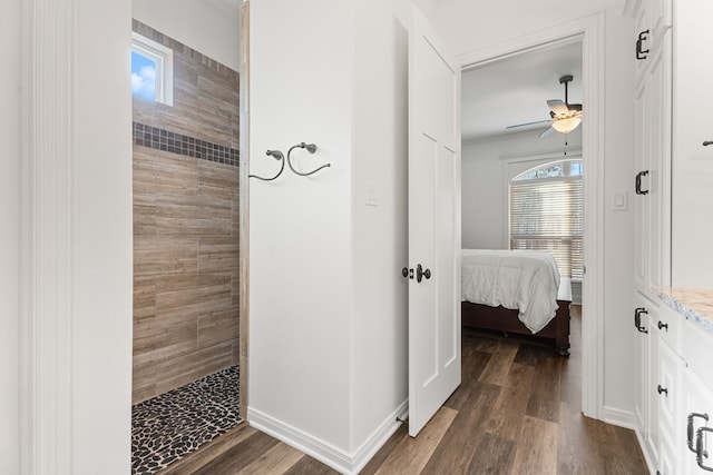 ensuite bathroom with vanity, walk in shower, connected bathroom, and wood finished floors