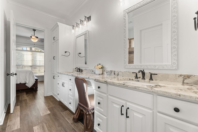 full bath with connected bathroom, wood finished floors, a sink, and double vanity