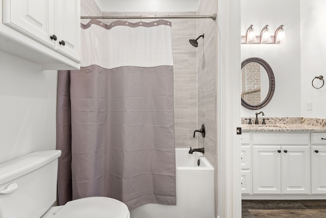bathroom with toilet, shower / bath combo, and vanity