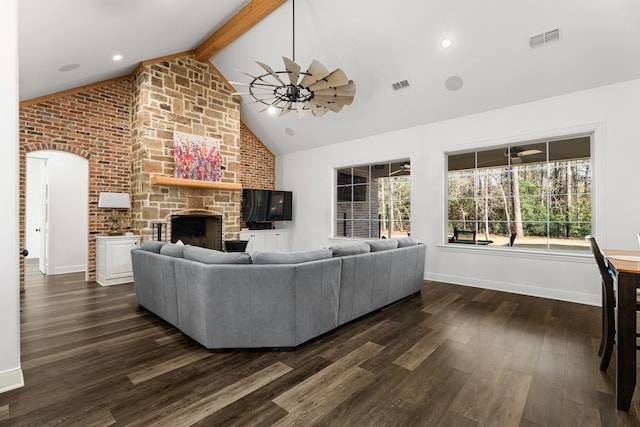 living area featuring high vaulted ceiling, beam ceiling, dark wood-style flooring, and visible vents