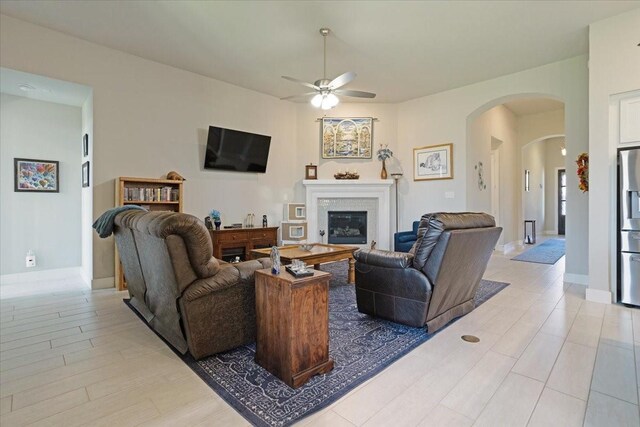 4024 Rosin St, Aubrey, TX 76227 - living area featuring a ceiling fan, a glass covered fireplace, and arched walkways