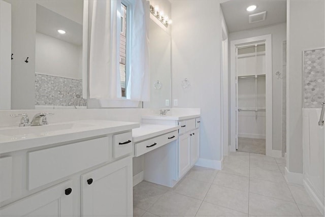4024 Rosin St, Aubrey, TX 76227 - bathroom featuring visible vents, vanity, tile patterned flooring, and a walk in closet