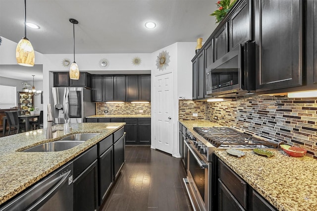4424 Dashland Dr, Celina, TX 75009 - kitchen with decorative light fixtures, sink, light stone counters, dark wood-type flooring, and appliances with stainless steel finishes