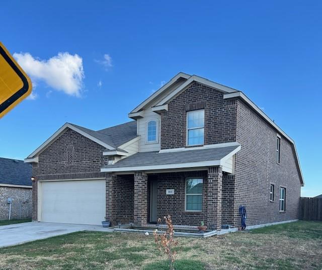 front of property featuring a front lawn and a garage