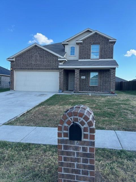 front of property featuring a garage and a front lawn