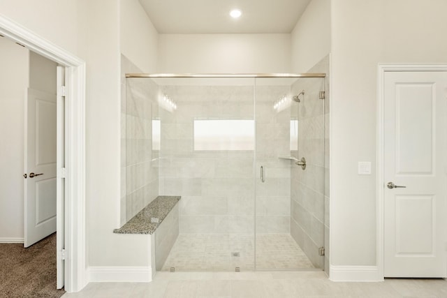bathroom with baseboards, recessed lighting, and a stall shower
