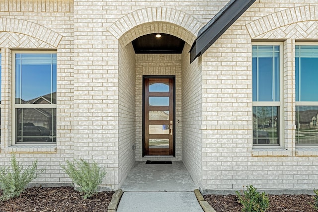 property entrance with brick siding