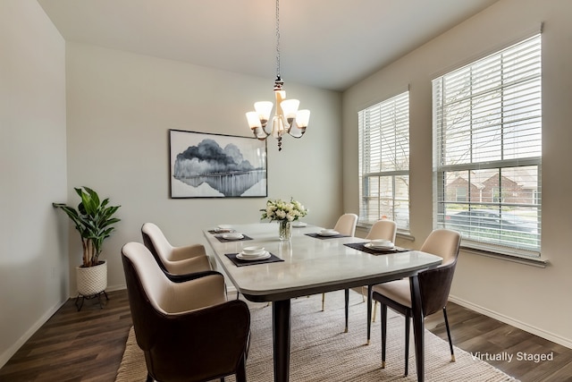 dining room featuring dark hardwood / wood-style flooring and a notable chandelier