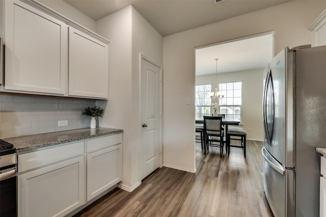 kitchen featuring white cabinetry, appliances with stainless steel finishes, and tasteful backsplash