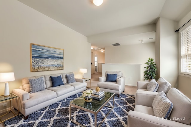 living room featuring plenty of natural light and carpet floors