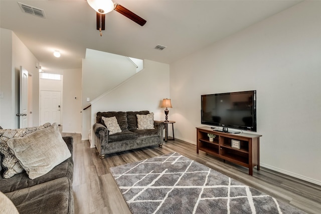 living room featuring hardwood / wood-style flooring and ceiling fan